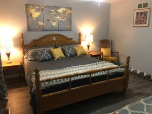 um quarto com uma cama de madeira com 2 mesas e 2 candeeiros em Red Brick Country Inn em Columbus