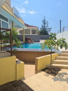 a swimming pool in the backyard of a house at Pastello guest house in Maputo