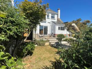 ein weißes Haus mit einem Hof davor in der Unterkunft Sunny Days: Beautiful Spacious 4 bed house in Torquay