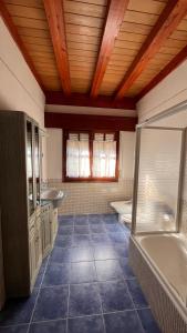 a large bathroom with two sinks and a tub at Villa Artegoikoa in Ibarrangelu