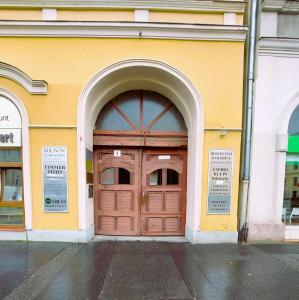 a large wooden door on the side of a building at Central Gallery Apartment in Debrecen