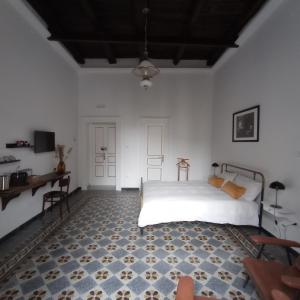 a bedroom with a bed and a table and a desk at La Casa Nova in Naples