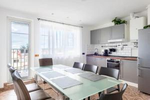 a kitchen with a table and chairs in a kitchen at Huge 5-bedrooms apartment near Prague Castle in Prague
