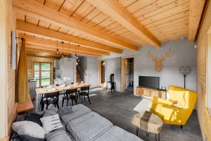 a living room with a couch and a table at Gabreta apartments in Stachy