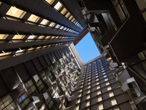 an overhead view of a tall building with a large window at Herloom Hotel & Residence BSD Tangerang in Tangerang