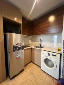 a kitchen with a refrigerator and a washing machine at COC00N by IVY in Lagos
