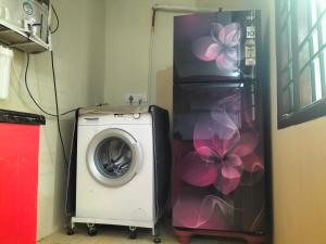 a washing machine in a room with a washer at vinoth in Mannārgudi