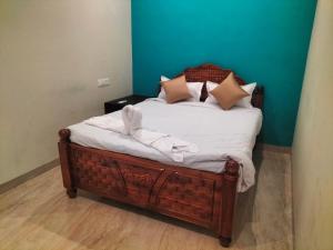 a bed with white sheets and pillows on it at vinoth in Mannārgudi