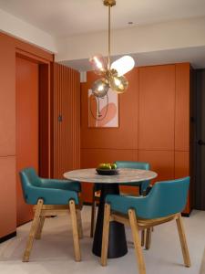 a dining room with a table and chairs at Herloom Hotel & Residence BSD Tangerang in Tangerang
