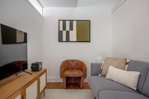 a living room with a couch and a tv at Midtown East 2br w elevator nr train NYC-1255 in New York