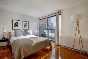 a bedroom with a bed and a large window at Midtown East 2br w elevator nr train NYC-1255 in New York