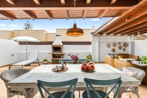 a dining room with a table and chairs on a patio at Lanzarote Villa Aira in Playa Honda