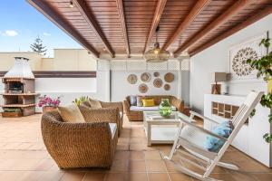 a patio with wicker furniture and a table and chairs at Lanzarote Villa Aira in Playa Honda