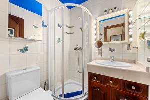 a bathroom with a shower and a toilet and a sink at Lanzarote Villa Aira in Playa Honda +21 photos