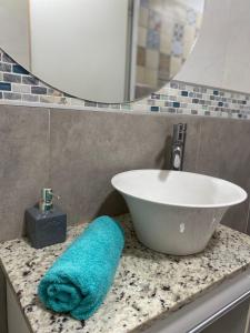 a bathroom with a sink and a towel on a counter at Mi paraíso verde in Junín +6 photos