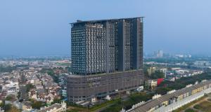 an overhead view of a tall building in a city at Herloom Hotel & Residence BSD Tangerang in Tangerang