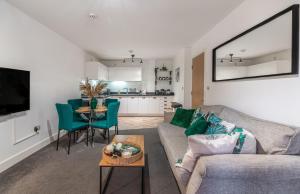 a living room with a couch and a table at Mailbox 2 bed Apartment Birmingham City Centre - Free Parking in Birmingham