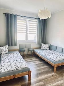 Postel nebo postele na pokoji v ubytování Śpij w Kudowie Apartament i pokoje gościnne