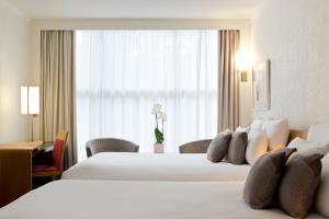 Postel nebo postele na pokoji v ubytování Novotel Genève Centre + 37 fotografií
