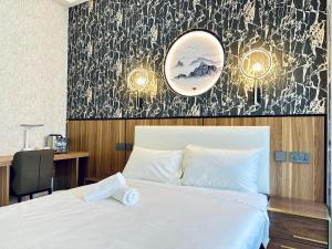 a bedroom with a white bed and a mirror at Kam Leng Hotel in Singapore