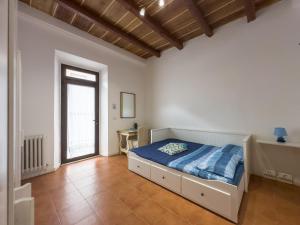 a bedroom with a bed and a large window at Host4All casa vacanze in Falconara Marittima