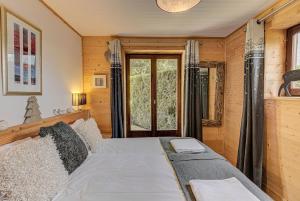 a bedroom with a bed and a window at Apartment Cry - Alpes Travel - Central Chamonix (sleeps 2-4) in Chamonix-Mont-Blanc