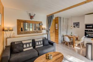 a living room with a couch and a table at Apartment Cry - Alpes Travel - Central Chamonix (sleeps 2-4) in Chamonix-Mont-Blanc