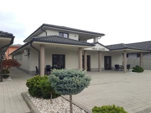 a house with a courtyard in front of it at Vila Lexus in Veľký Meder