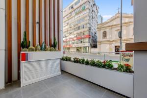 a counter with cactuses and plants on a city street at Ibos Hotels Izmir Alsancak in Alsancak