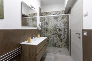 a bathroom with a sink and a shower at Garden House in Pianillo +70 photos