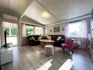 a living room with a couch and a table at Cozy cottage in Kil near lake Fryken in Kil