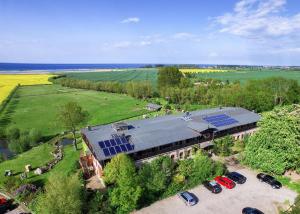 an aerial view of a building with solar panels on it at Pension Schmelzer in Kägsdorf