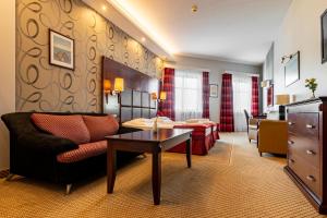 a living room with a couch and a table at Hotel Galicja Superior Wellness & Spa in Oświęcim