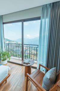 a living room with a large window with a view at Sapa Yen Hotel in Sa Pa