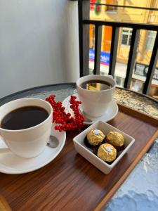 two cups of coffee and cookies on a table at S a f e Residence Patong in Patong Beach