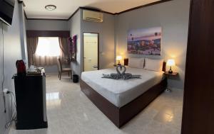 a bedroom with a bed with a towel on it at S a f e Residence Patong in Patong Beach