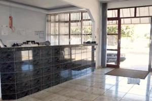 a kitchen with a counter in a room with a window at Hotel Imperador in Caldas Novas