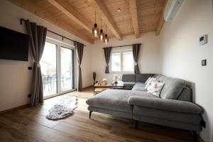 a living room with a couch and a large window at Sonnendörfl in Poppendorf im Burgenland