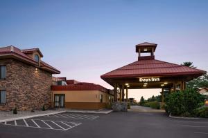a building with a gazebo in a parking lot at Days Inn & Suites by Wyndham Bozeman in Bozeman