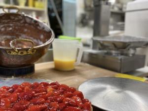 a pile of red food on a counter in a kitchen at Hotel Strand-Café mit Gästehaus Charlotte in Langenargen