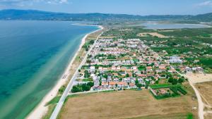 an aerial view of a beach with houses and the ocean at Argilos Residential Complex in Ofrínion