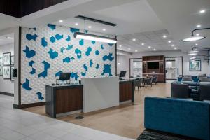 an office with a lobby with chairs and a wall at Hyatt Place Titusville Kennedy Space Center in Titusville