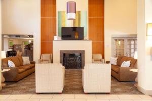 a living room with couches and a fireplace at Comfort Suites Medical District near Mall of Louisiana in Baton Rouge