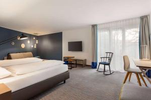Postel nebo postele na pokoji v ubytování Vienna House Easy by Wyndham Trier