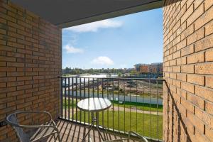 a balcony with a table and a view of a river at Grand Apartments Chlebova in Gdańsk