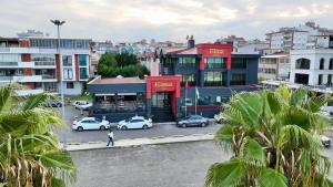 a building with cars parked in a parking lot at Elina Managed by Dedeman in Atakum