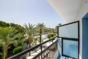 a balcony view of a resort with palm trees at The Blue Apartments - Adults Only in San Antonio