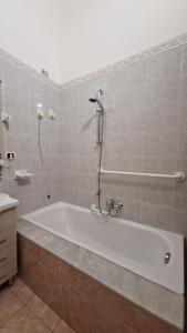 a bathroom with a bath tub and a shower at The Crazy House in Catania