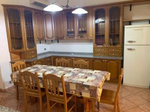 a kitchen with a table with chairs and a refrigerator at The Crazy House in Catania +15 photos