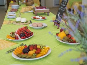 a table with plates of fruits and eggs on it at Azienda Agrituristica Scalelle in Otranto